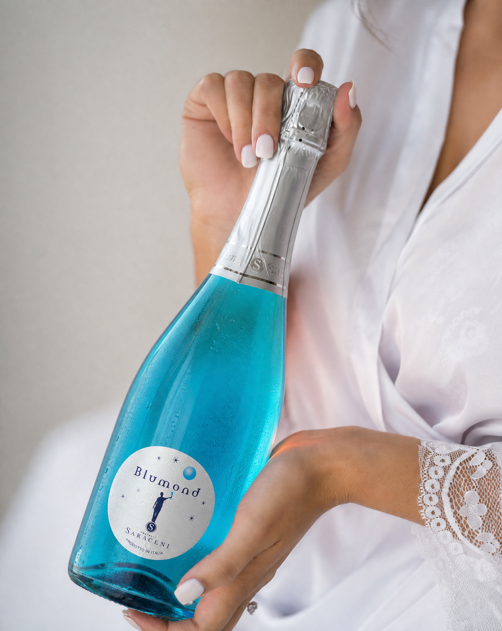 Blumond Blue Bubbly — bright blue Italian sparkling sweet wine, 750ml, Saraceni Wines (wedding lifestyle shot)